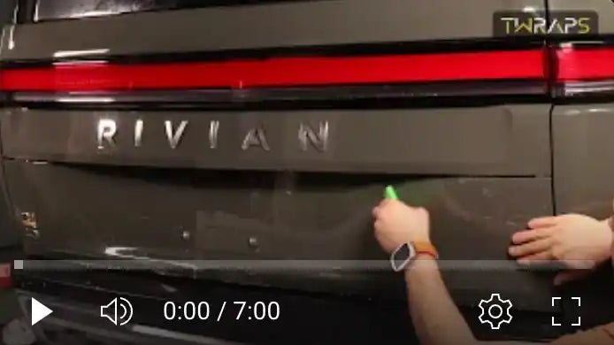 Rivian vehicle tailgate with illuminated lettering.