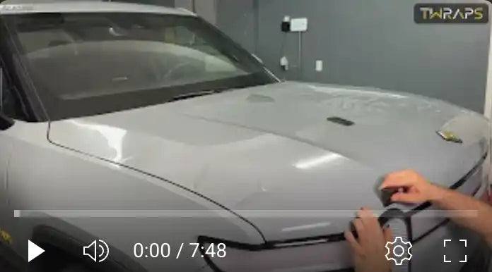 Silver Porsche vehicle being detailed or worked on.