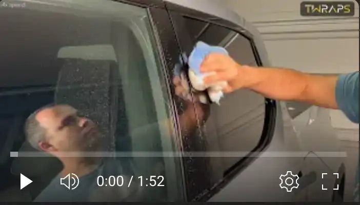 Video player showing someone cleaning a car window.