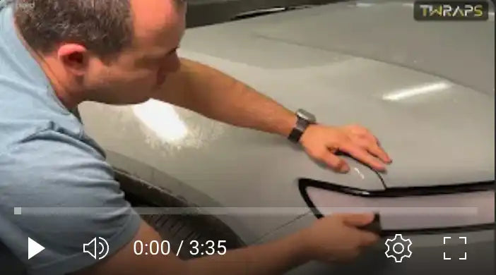 Video player interface showing someone working on what appears to be a car surface.