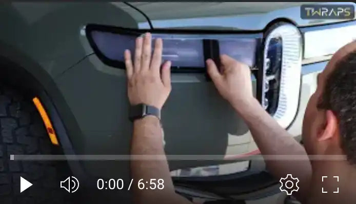 Video player interface showing hands installing what appears to be a car accessory.