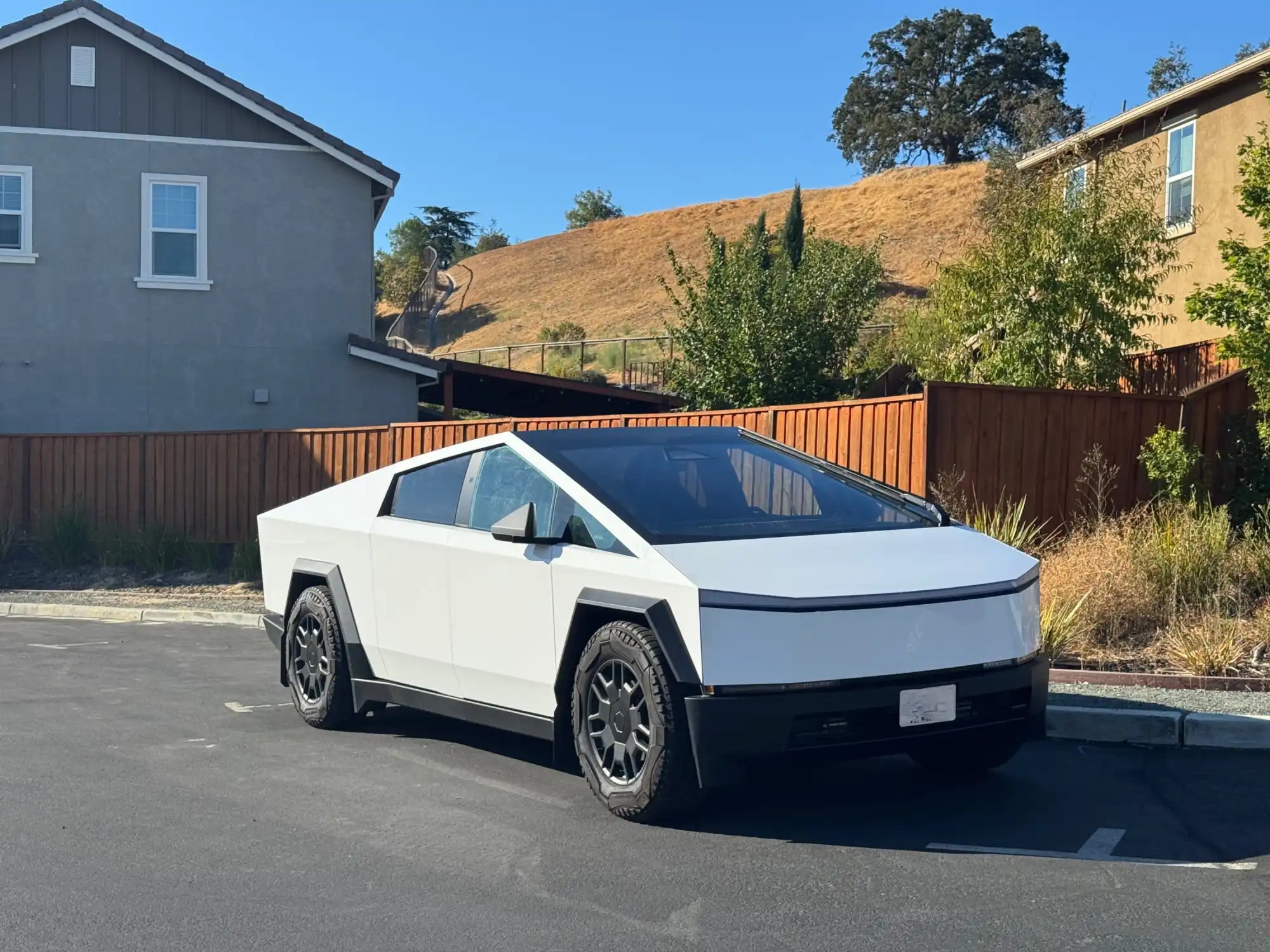 White Tesla Cybertruck parked with its distinctive angular design.